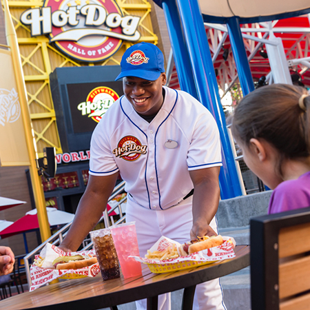 Team Member in baseball uniform working at the Hot Dog Hall of Fame