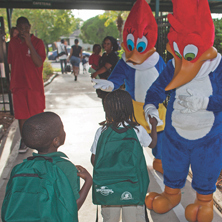 Children interact with Team Members dressed as Woody the Woodpecker and his girlfriend Winnie