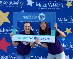 Two team member volunteers at a Make a Wish event
